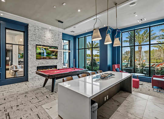 a game room with a pool table and blue walls at Altis Grand Suncoast, Florida, 34638
