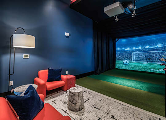 a game room with a soccer field and a projector screen at Altis Twin Lakes Apartments, Kissimmee, FL 34744
