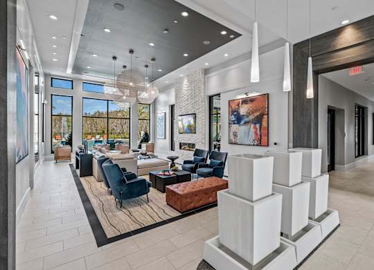 a lobby with couches and chairs and a reception area at Altis Grand Suncoast, Florida