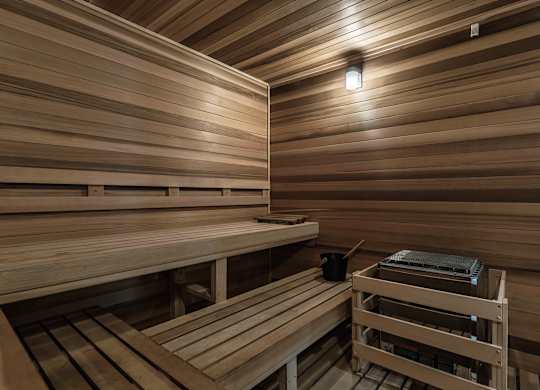 a sauna with wooden benches and a table at Altis Grand Suncoast, Florida