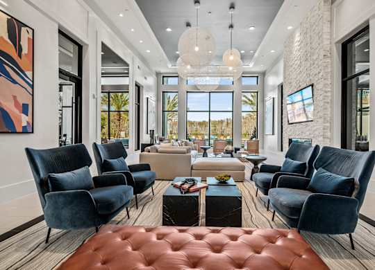 a living room with couches and chairs and a table  at Altis Grand Suncoast Apartments, Florida, 34638