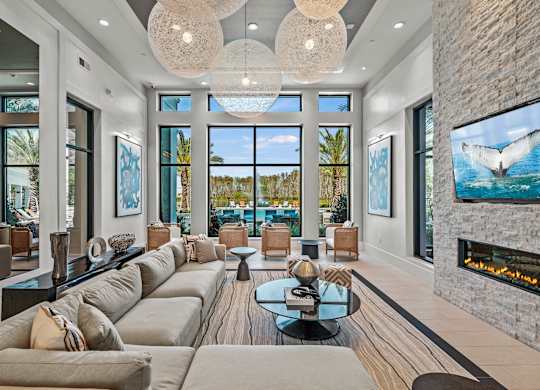 a living room with couches and a view of the ocean  at Altis Grand Suncoast, Land O' Lakes, 34638