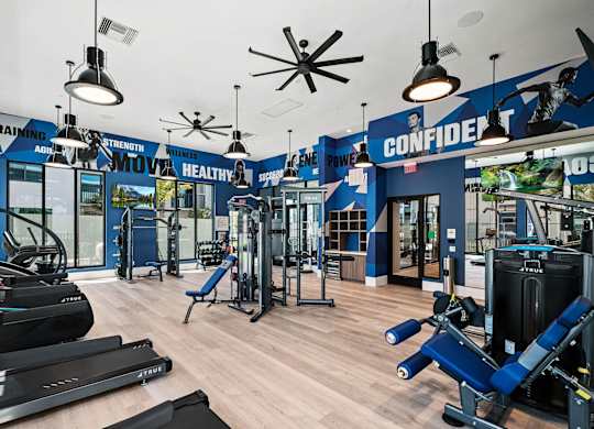 a gym with cardio machines and weights on a wooden floor at Altis Santa Barbara, Naples, 34104