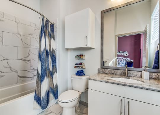 Apartments for Rent Lewisville - Hebron 121 Station - Bathroom With Tile Flooring, Cabinets, and a Modern Shower