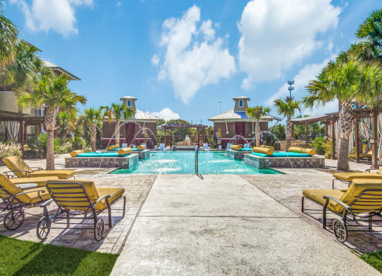 Three-Bedroom Apartments In Lewisville, TX - Hebron 121 Station - Grotto Pool with Tanning Areas, Cabanas, And Lounge Chairs