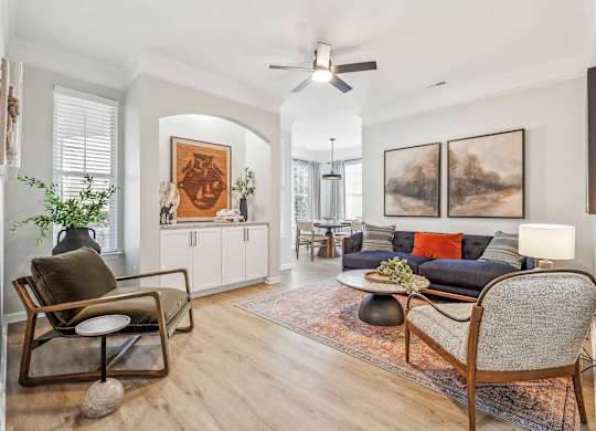 A living room with a chair, a sofa, and a table.