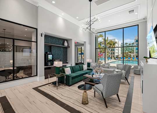 A modern living room with a green sofa and a view of the outside.
