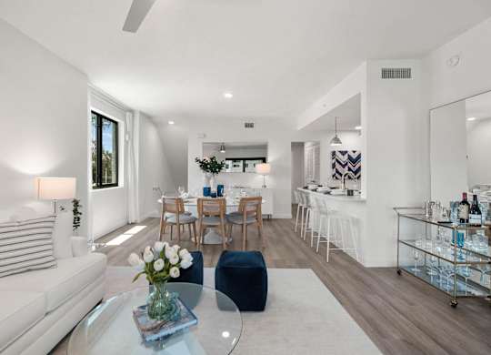 a living room with a couch and a table at Altis Santa Barbara, Naples, Florida