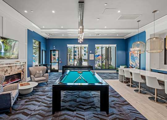 A room with a pool table and a fireplace.