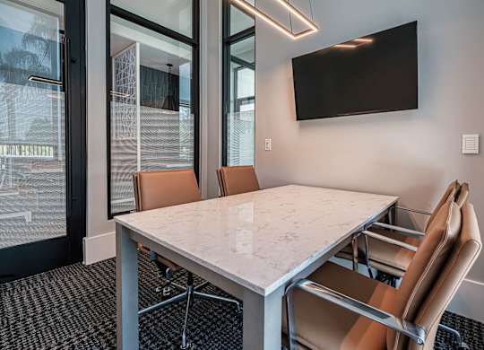 a conference room with a marble table and chairs at Altis Twin Lakes Apartments, Kissimmee, 34744