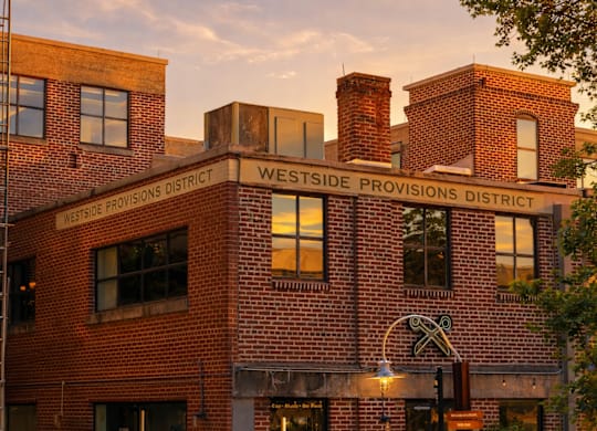 A red brick building with the words Westside Provisions District on it.