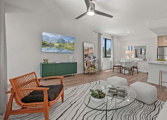 a living room with a couch and a table at Altis Santa Barbara, Florida, 34104