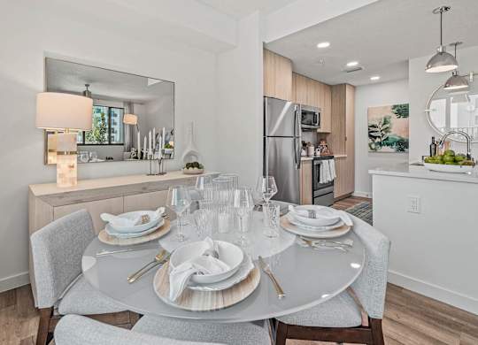 a dining room table with plates and chairs at Altis Santa Barbara, Florida
