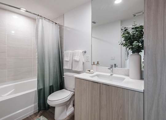 a bathroom with a shower toilet and sink at Altis Santa Barbara, Naples, 34104