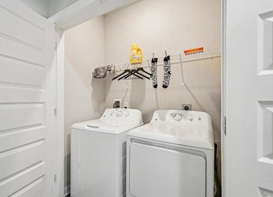A small laundry room with a washer and dryer.