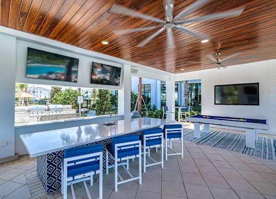 a bar area with a pool table and a television at Altis Twin Lakes Apartments, Kissimmee, Florida