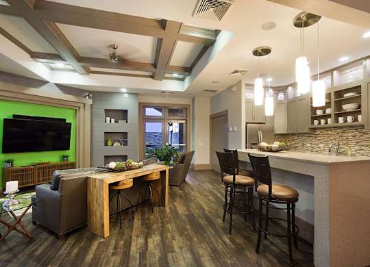 A modern kitchen with a bar area and a dining table.
