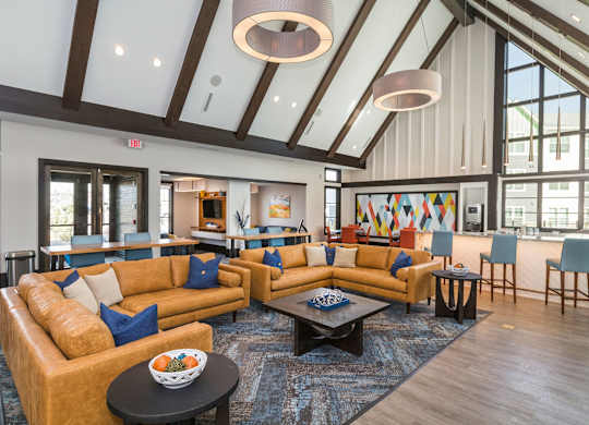 A large room with a high ceiling and a long couch.