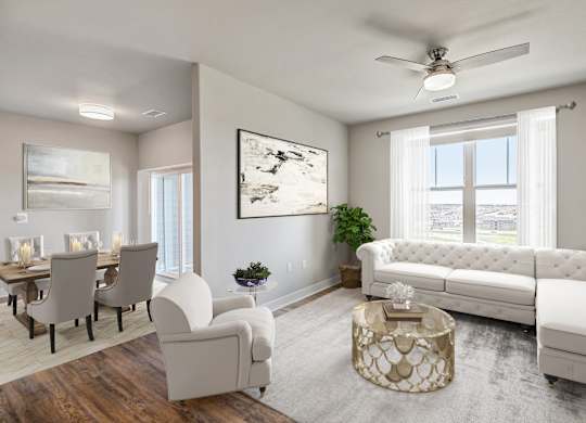 A living room with a white sofa, a coffee table, and a painting on the wall.