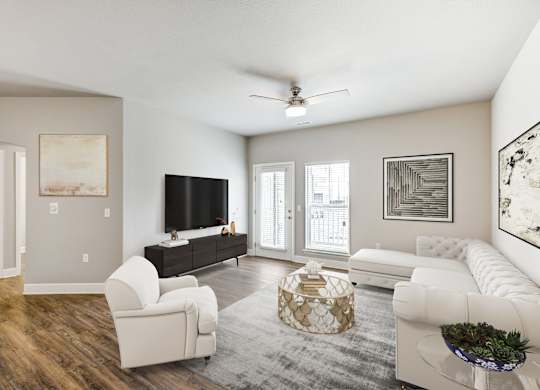A living room with a white couch, a white chair, a white coffee table, and a white rug.