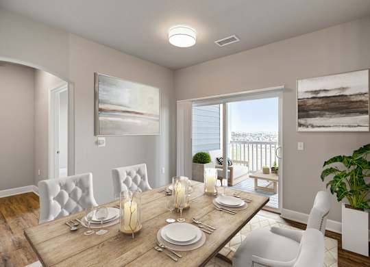 A dining room with a wooden table set for two.