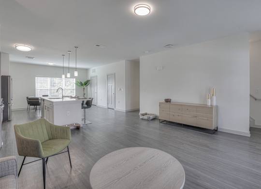 A modern living room with a green chair and a wooden coffee table.