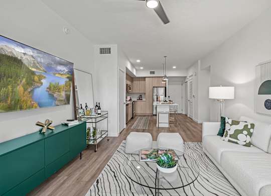 A living room with a white couch and a green cabinet.