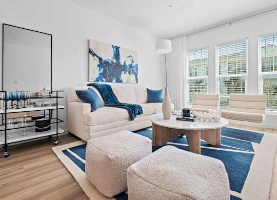 a living room filled with furniture and a large window at Altis Twin Lakes Apartments, Kissimmee, FL 34744