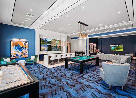 a game room with a pool table and couches at Altis Santa Barbara, Florida