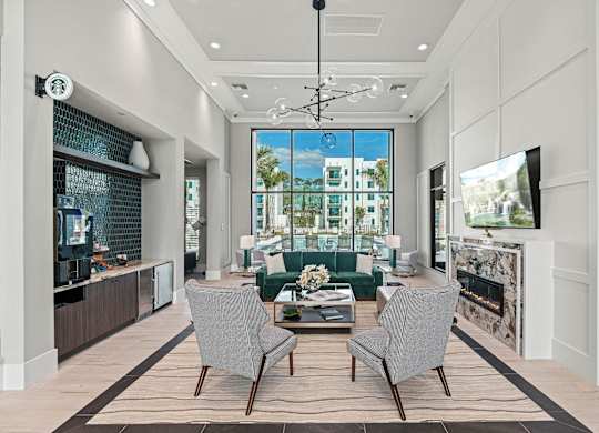a living room with a fireplace and a large window at Altis Santa Barbara, Naples, FL
