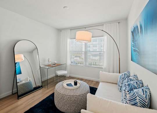 a living room with a couch and a mirror at Altis Twin Lakes Apartments, Florida, 34744