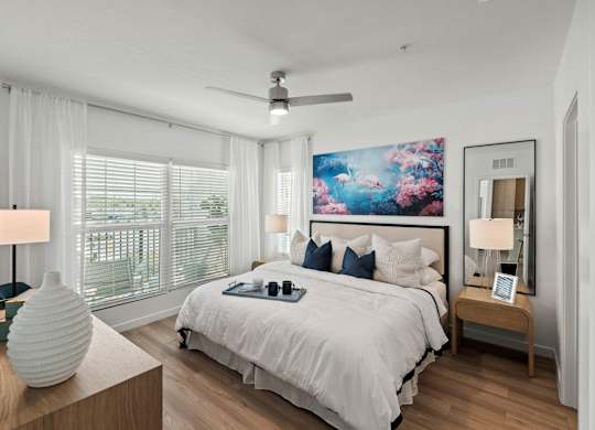 a bedroom with a large bed and a ceiling fan at Altis Twin Lakes Apartments, Florida