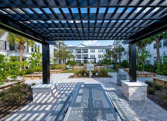 A walkway with a metal grate and a black pole on either side.