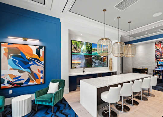 a dining room with blue walls and a white table and chairs at Altis Santa Barbara, Florida, 34104