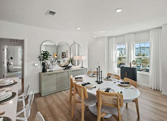 a dining room and living room with a table and chairs at Altis Twin Lakes Apartments, Kissimmee, 34744