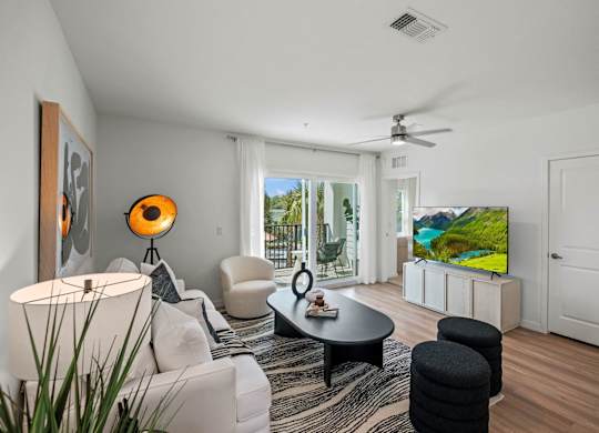 a view of a lobby with white walls and chairs and a glass table at Altis Twin Lakes Apartments, Kissimmee, FL