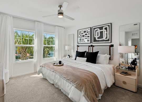 a bedroom with a bed and a ceiling fan at Altis Twin Lakes Apartments, Kissimmee, FL