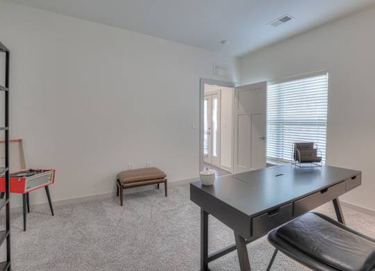 A room with a table and chairs.