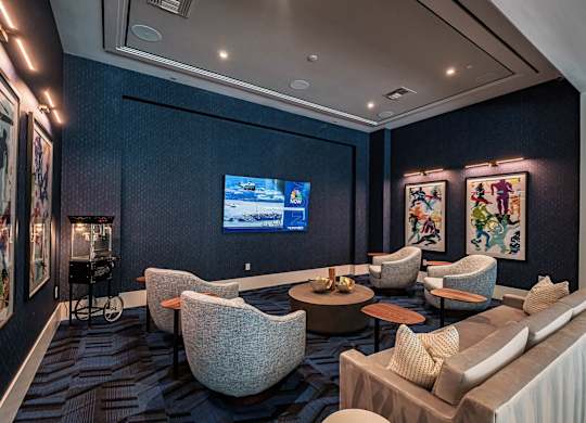 a living room with couches and chairs and a television at Altis Santa Barbara, Naples, FL