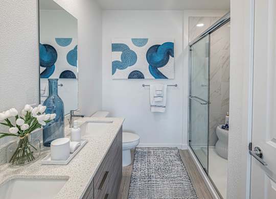 A bathroom with a white sink and a white toilet.