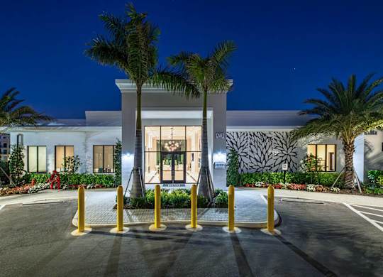 A modern building with a palm tree in front.