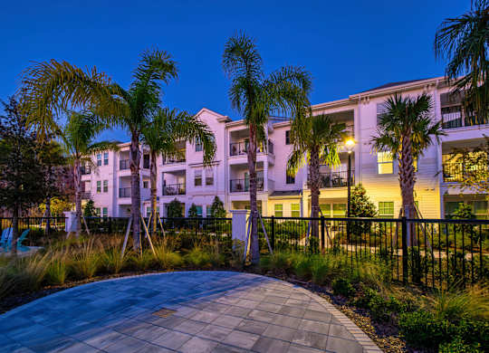 A building with a palm tree in front of it.