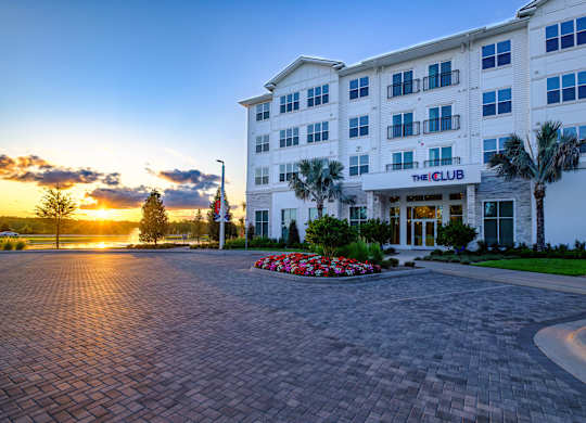 The Club hotel building with a driveway in front.