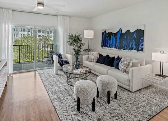 a living room with a couch and a tv at Altis Grand Lake Willis, Orlando Florida