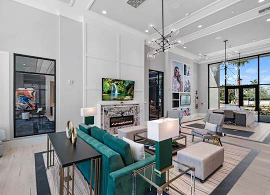 a living room with couches and chairs and a fireplace  at Altis Santa Barbara, Florida