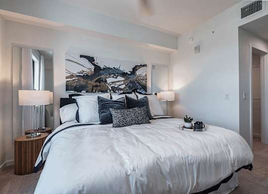 a bedroom with a large bed and a large window at Altis Santa Barbara, Naples, Florida