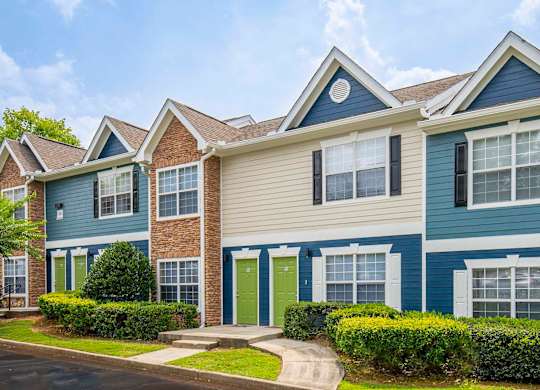 A row of townhouses with blue and beige siding.