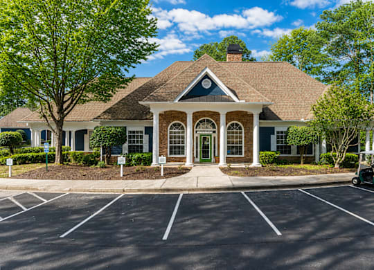 A building with a green lawn in front.