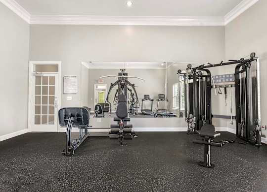 A spacious home gym with a variety of equipment.