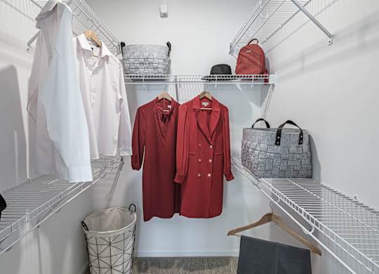 a walk in closet filled with clothes and bags at Altis Grand Lake Willis, Orlando, FL